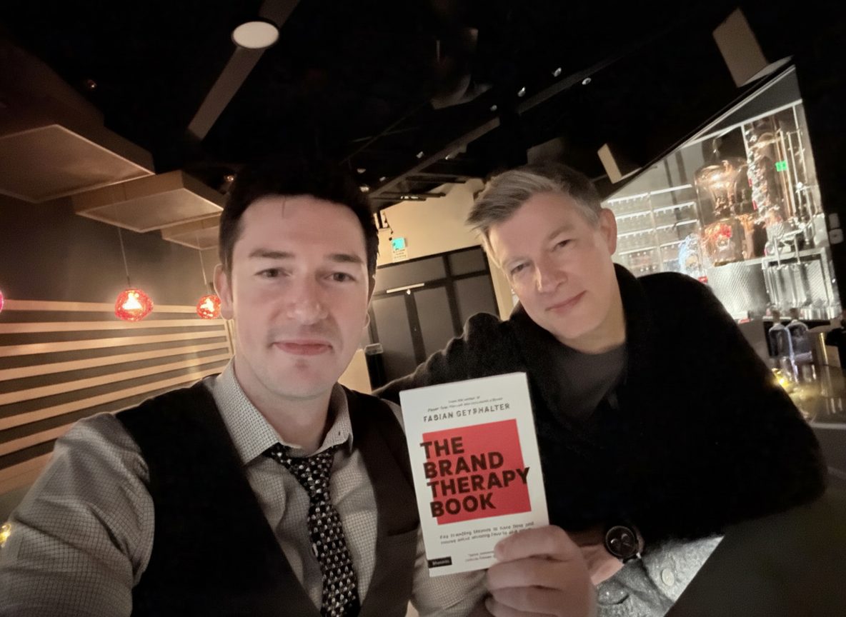 Florian with Fabian Geyrhalter, holding the Brand Therapy book.